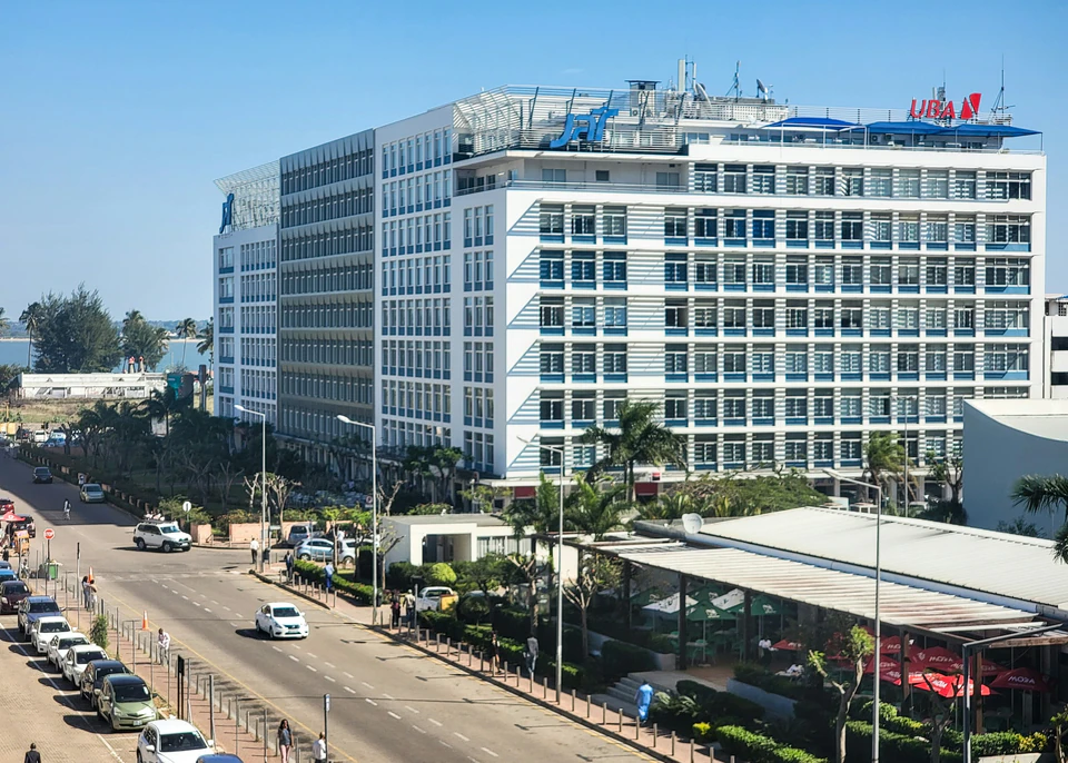 A large white building sitting on the side of a road.