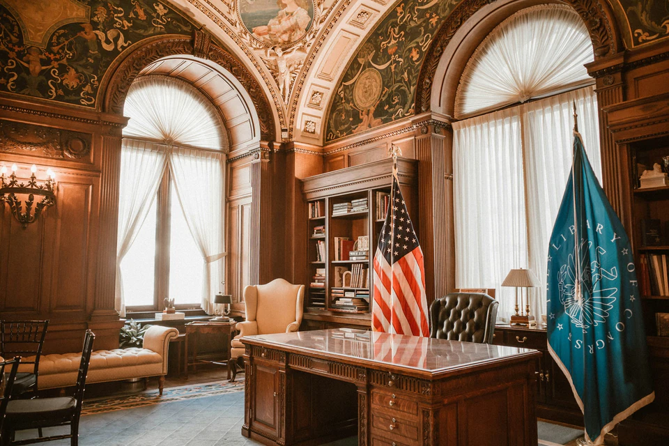 Elegant office with american flag and presidential desk.