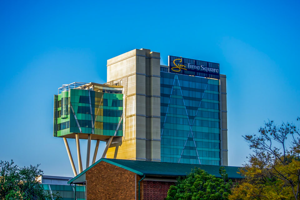 Modern office building with glass facade and unique structure.