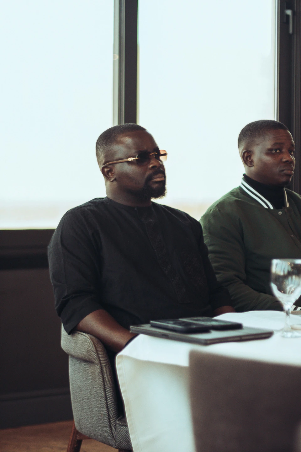 Two men sitting at a table indoors.