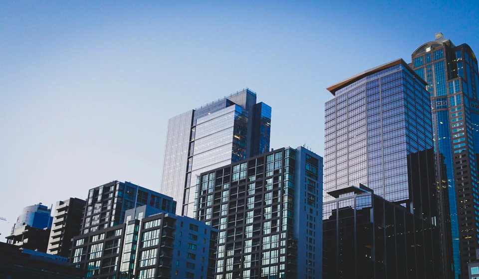 White and blue glass walled high rise building.