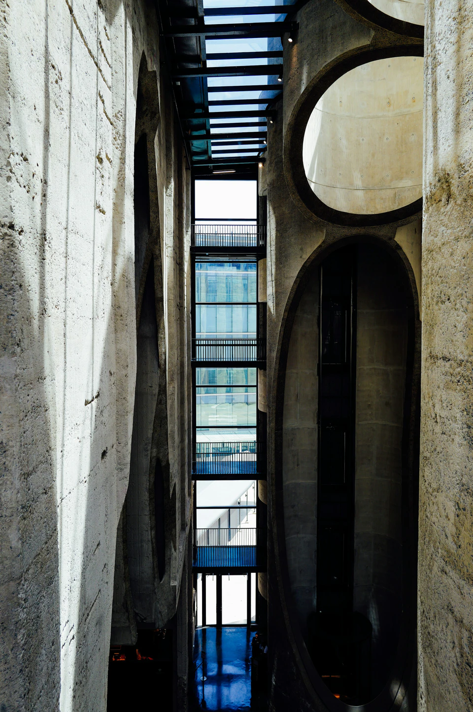 Modern building interior with concrete walls and glass windows.