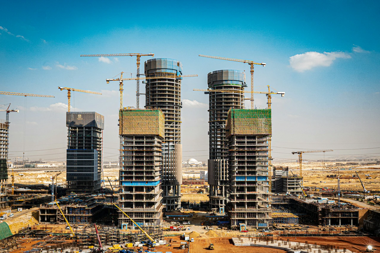 A group of tall buildings under construction.